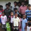 Students outside their new classroom with their teacher, Suresh.  